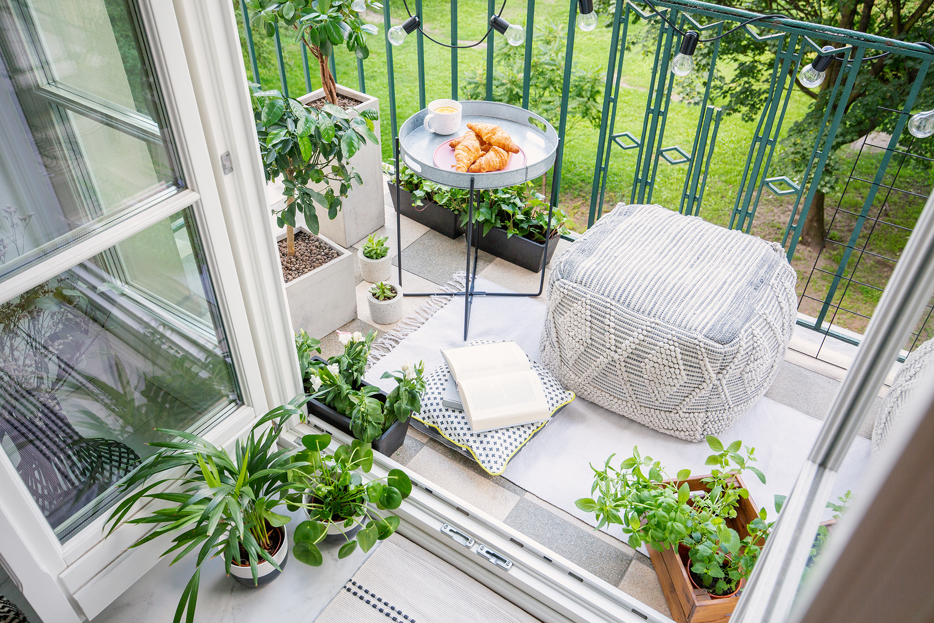 Cozying up the small balcony with rugs and pillows, giving a personal style into the outdoor oasis